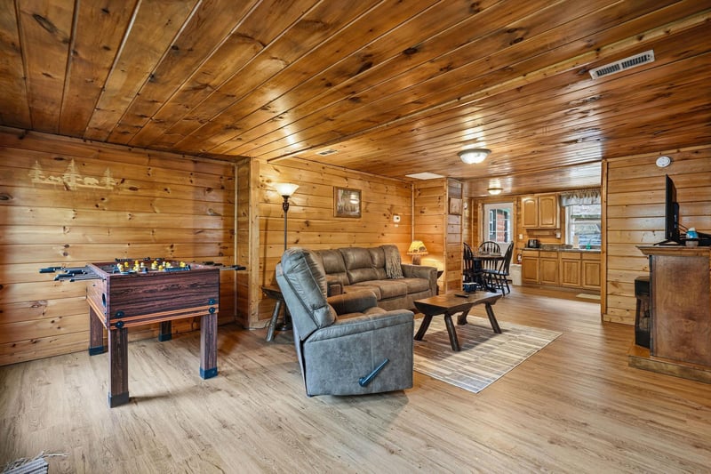 Relax in your cozy cabin with warm wood walls, plush recliners, and a fun foosball table for evening entertainment.