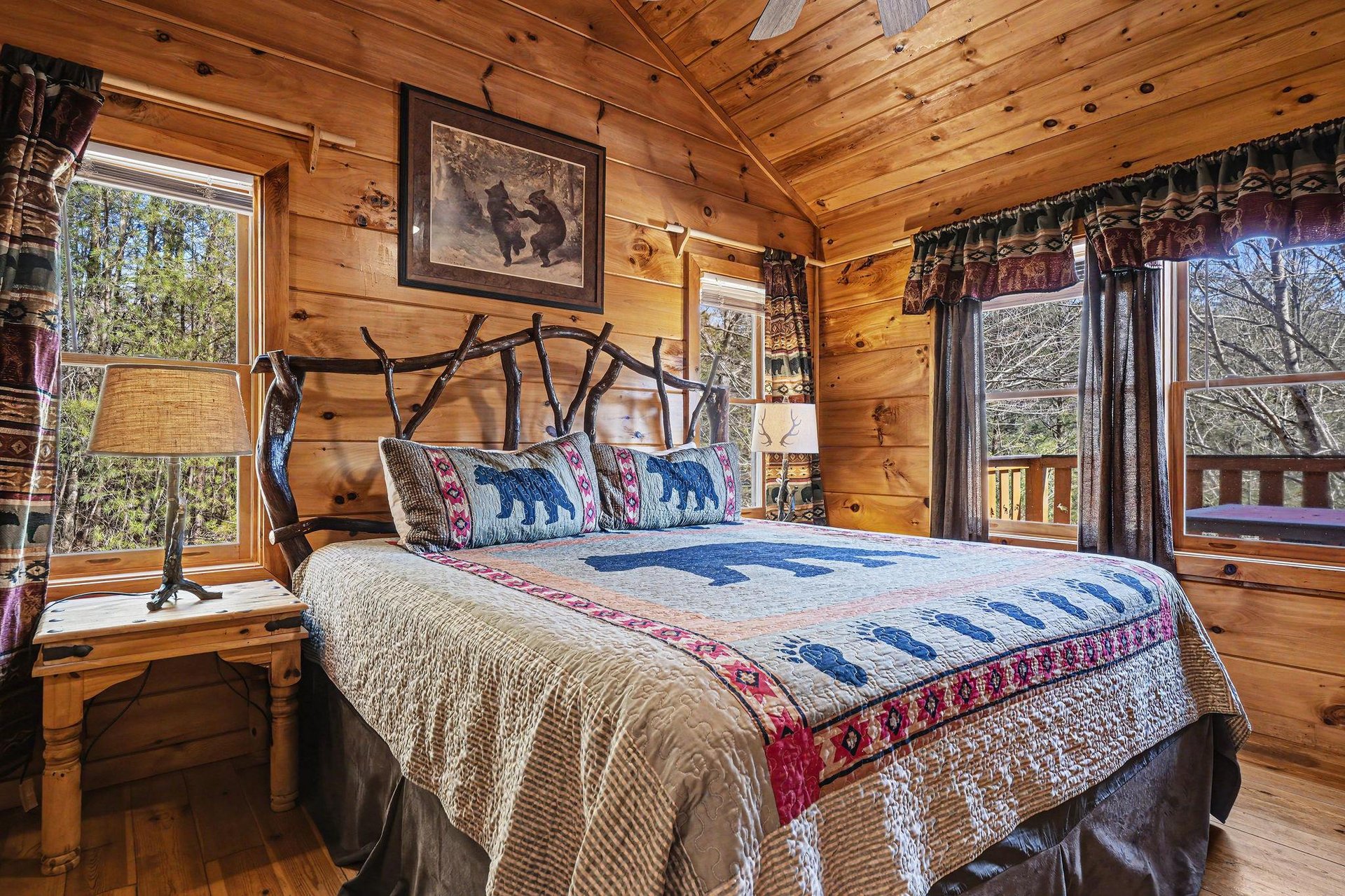 Cozy up in your rustic bedroom with handcrafted log walls, wildlifethemed bedding, and peaceful forest views through charming windows.