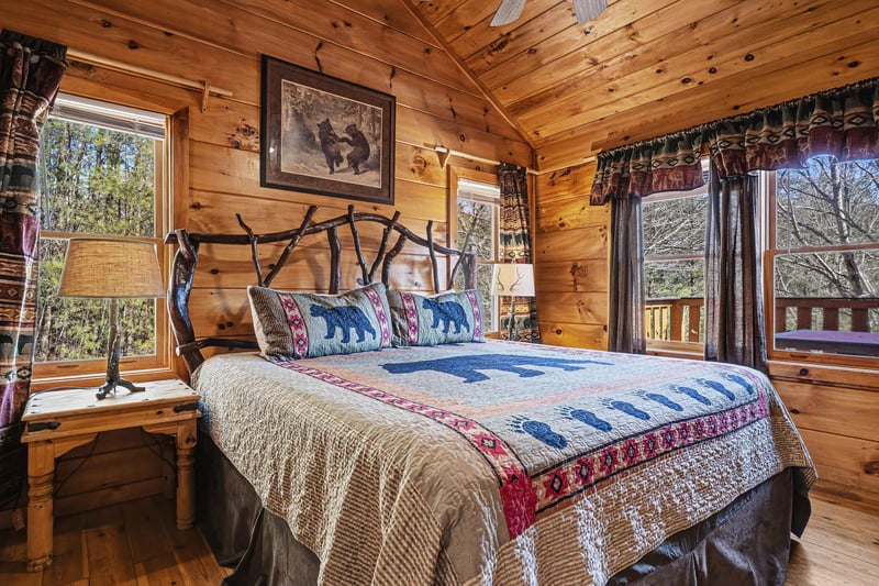 Cozy up in your rustic bedroom with handcrafted log walls, wildlifethemed bedding, and peaceful forest views through charming windows.