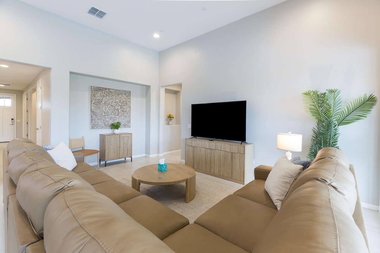 Sectional couch that provides ample seating, flatscreen TV, and openconcept living.