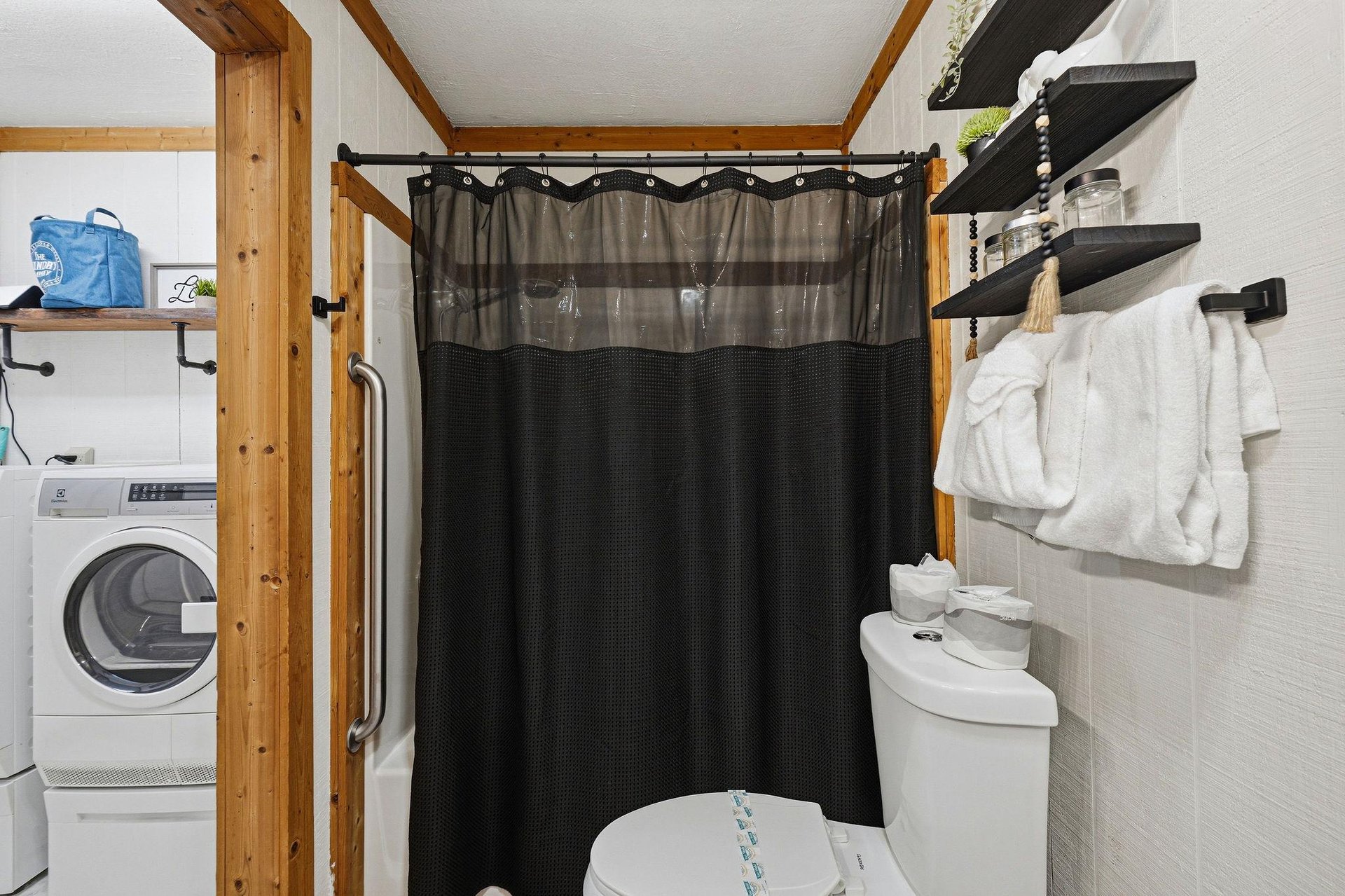 Your private bathroom features a walkin shower with exposed wooden beams, plus insuite laundry for ultimate convenience during your stay.