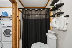 Your private bathroom features a walkin shower with exposed wooden beams, plus insuite laundry for ultimate convenience during your stay.