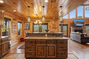 Unwind in your openconcept retreat with soaring woodpaneled ceilings, a cozy fireplace, and stunning mountain vistas from every window.