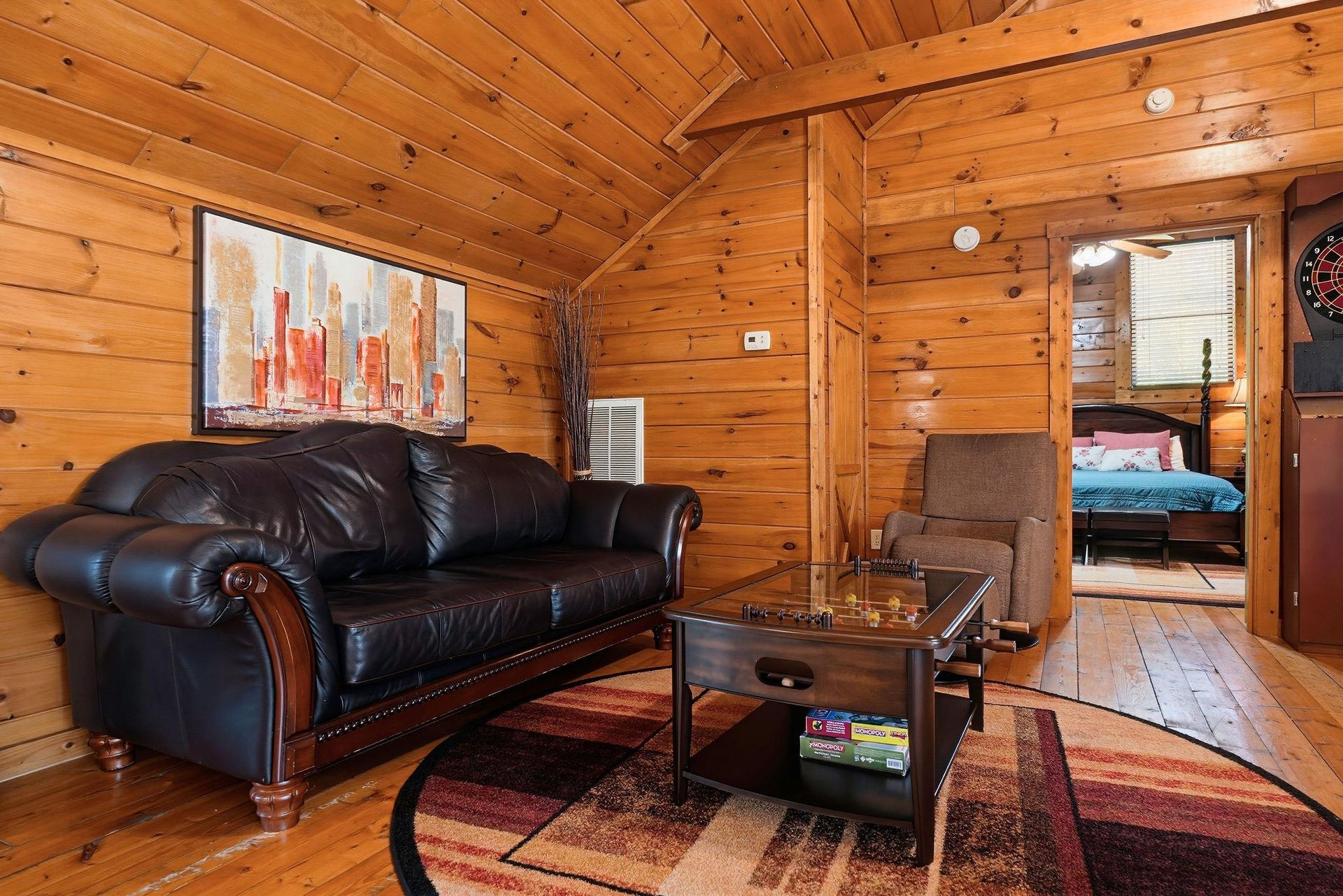 Sink into the rich leather sofa and feel the warmth of natural wood surrounding you. Your cabin retreat invites relaxation with its cozy living space and charming rustic character.