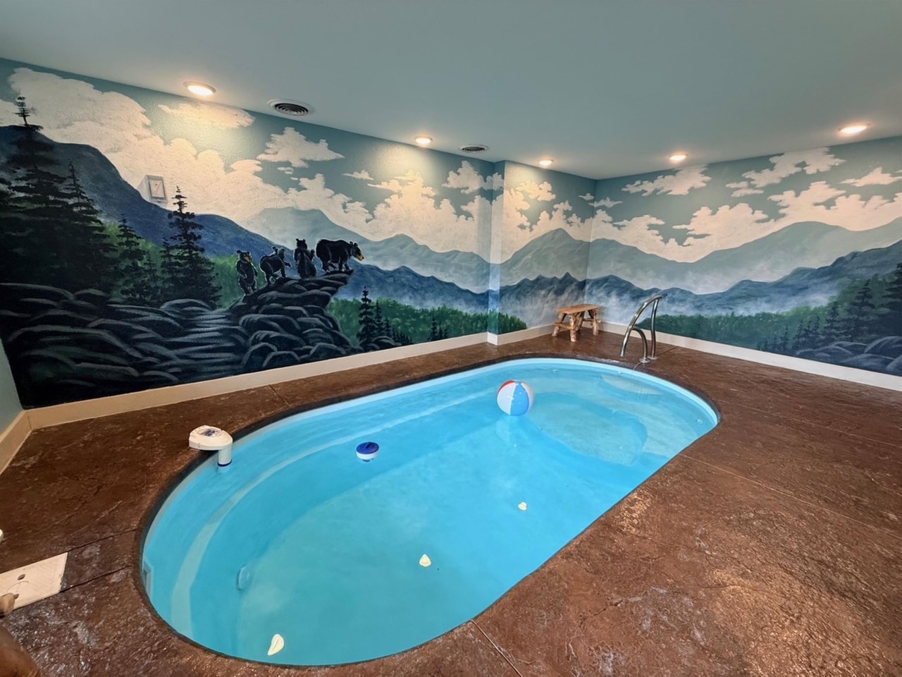 Dive into your private mountain oasis with stunning wilderness murals surrounding your indoor pool escape.