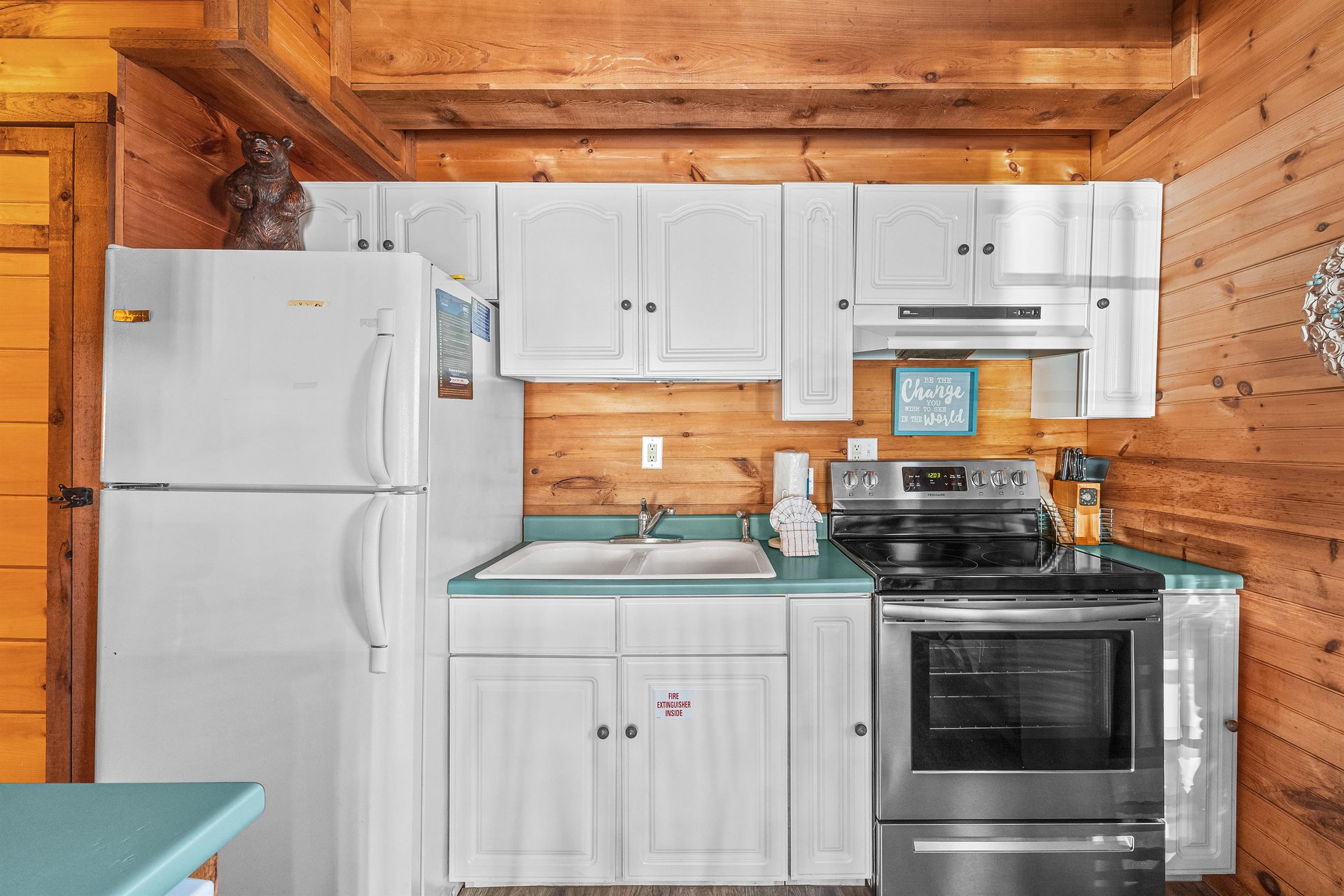 Kitchen with white cabinets and appliances at Living on Love, a 2 bedroom cabin rental located in Pigeon Forge
