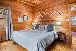 King bed with mountains decor above on wall