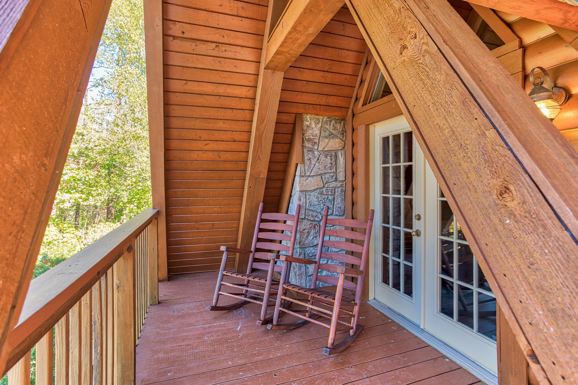 Rocking chairs on the upper deck at Living on Love, a 2 bedroom cabin rental located in Pigeon Forge