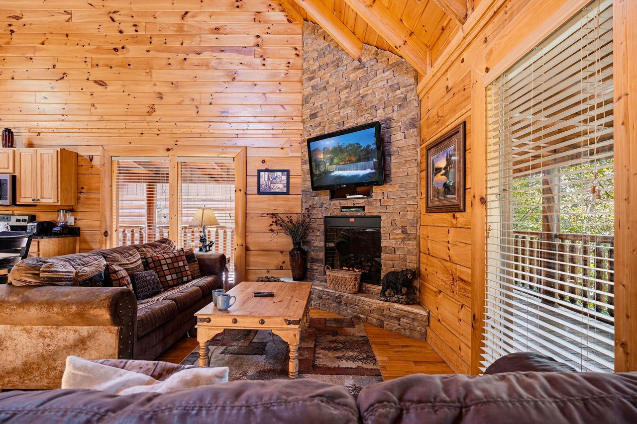 Sink into plush seating by the stone fireplace and let the natural light streaming through floortoceiling windows envelop you in warmth and tranquility.
