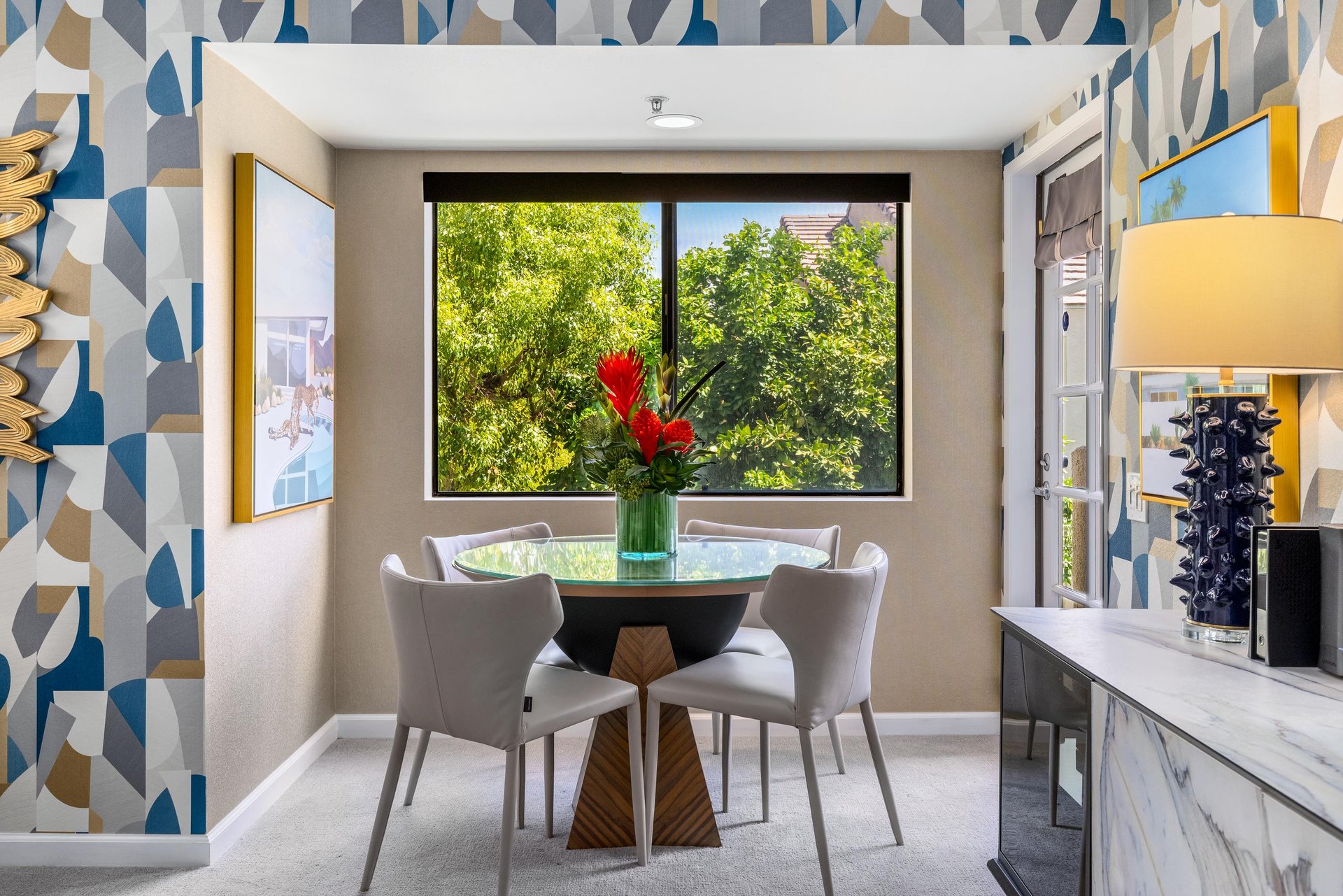 Dining table and chairs for 4 guests. View of the door leading out to the balcony.