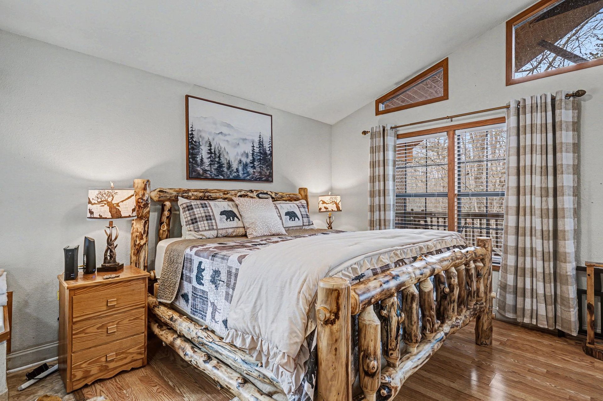 Cozy up in this rustic bedroom with its handcrafted log bed and mountainthemed bedding, where your woodland retreat dreams come true.