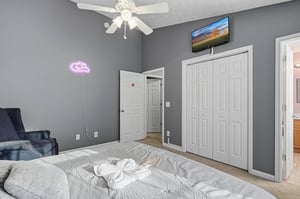 Unwind in your stylish bedroom with cozy seating, entertainment, and thoughtful touches like fun neon lighting to make your stay memorable.