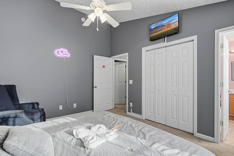 Unwind in your stylish bedroom with cozy seating, entertainment, and thoughtful touches like fun neon lighting to make your stay memorable.