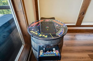 Challenge your friends to a round on this vintage arcade game table, a fun throwback piece that adds playful charm to your stay.