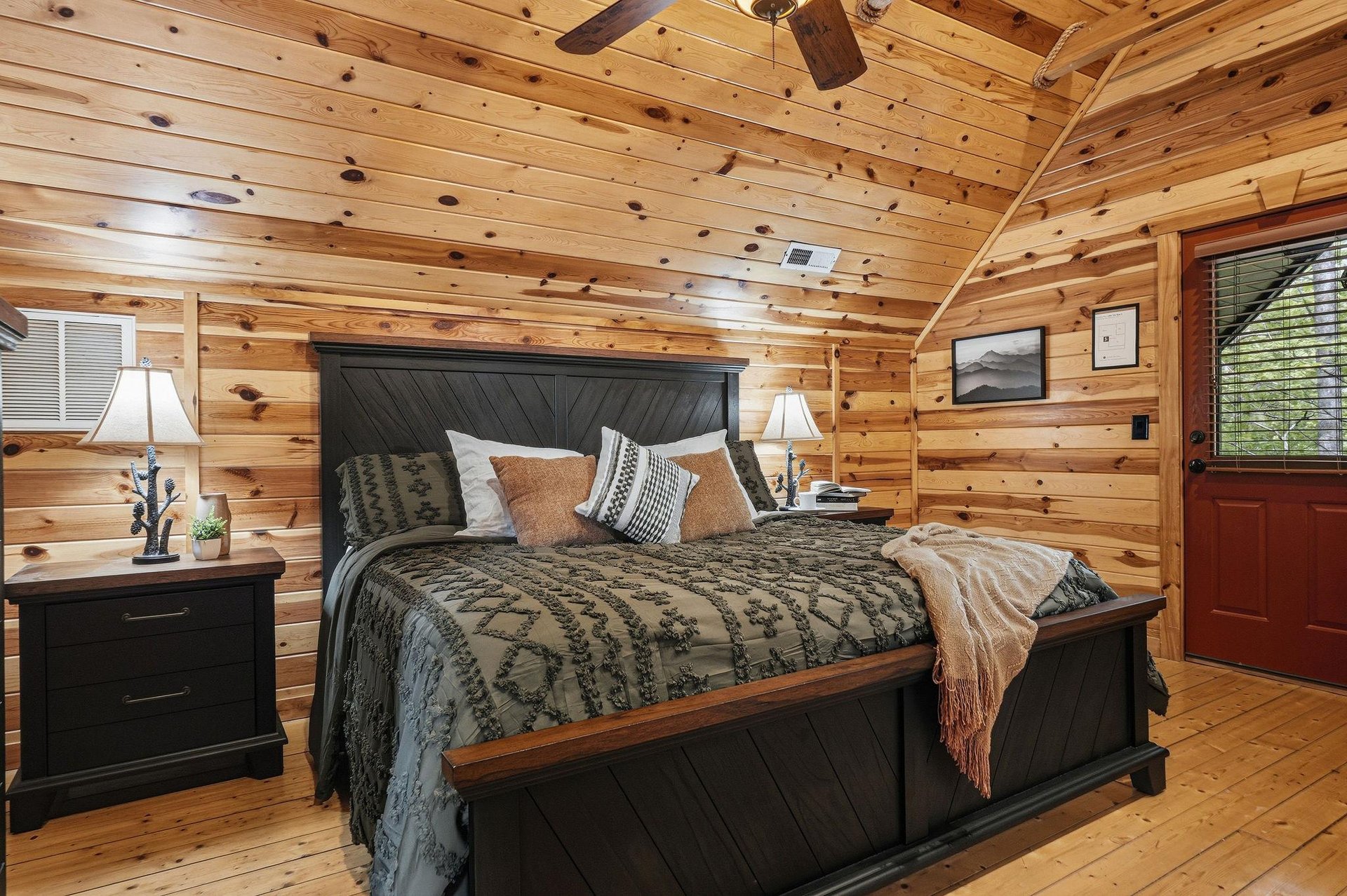 Unwind in your cozy log cabin bedroom where warm pine walls and rustic charm create the perfect mountain retreat sanctuary.