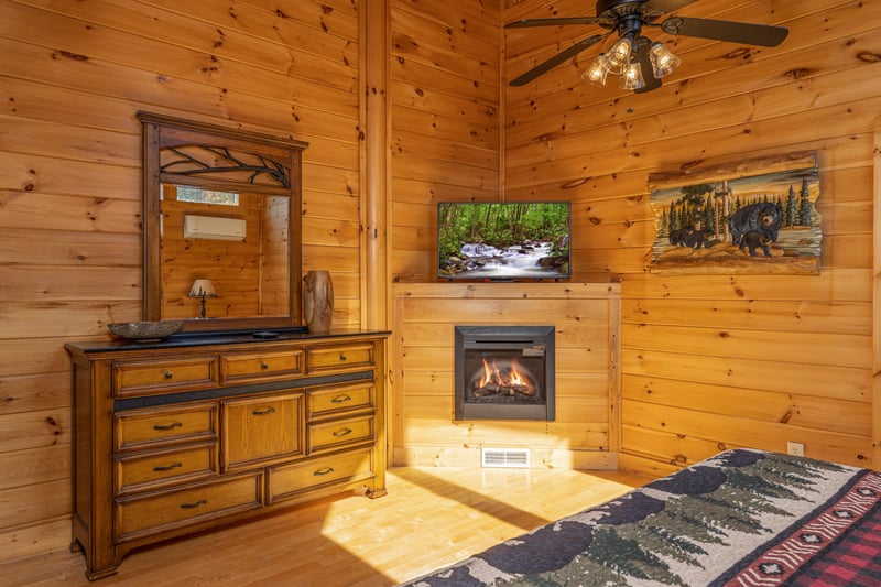 Dresser, fireplace, and TV in a bedroom at Bears Dont Bluff, a 3 bedroom cabin rental located in Pigeon Forge
