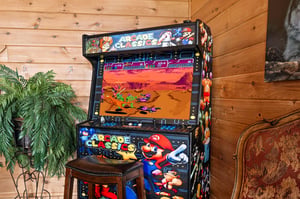 Step up to the vintage arcade machine and challenge your friends to classic games—perfect for funfilled evenings in your cozy cabin retreat.