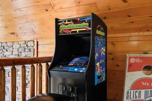 Classic arcade game brings retro fun to your mountain retreat. Challenge friends to high scores in this cozy game room corner.