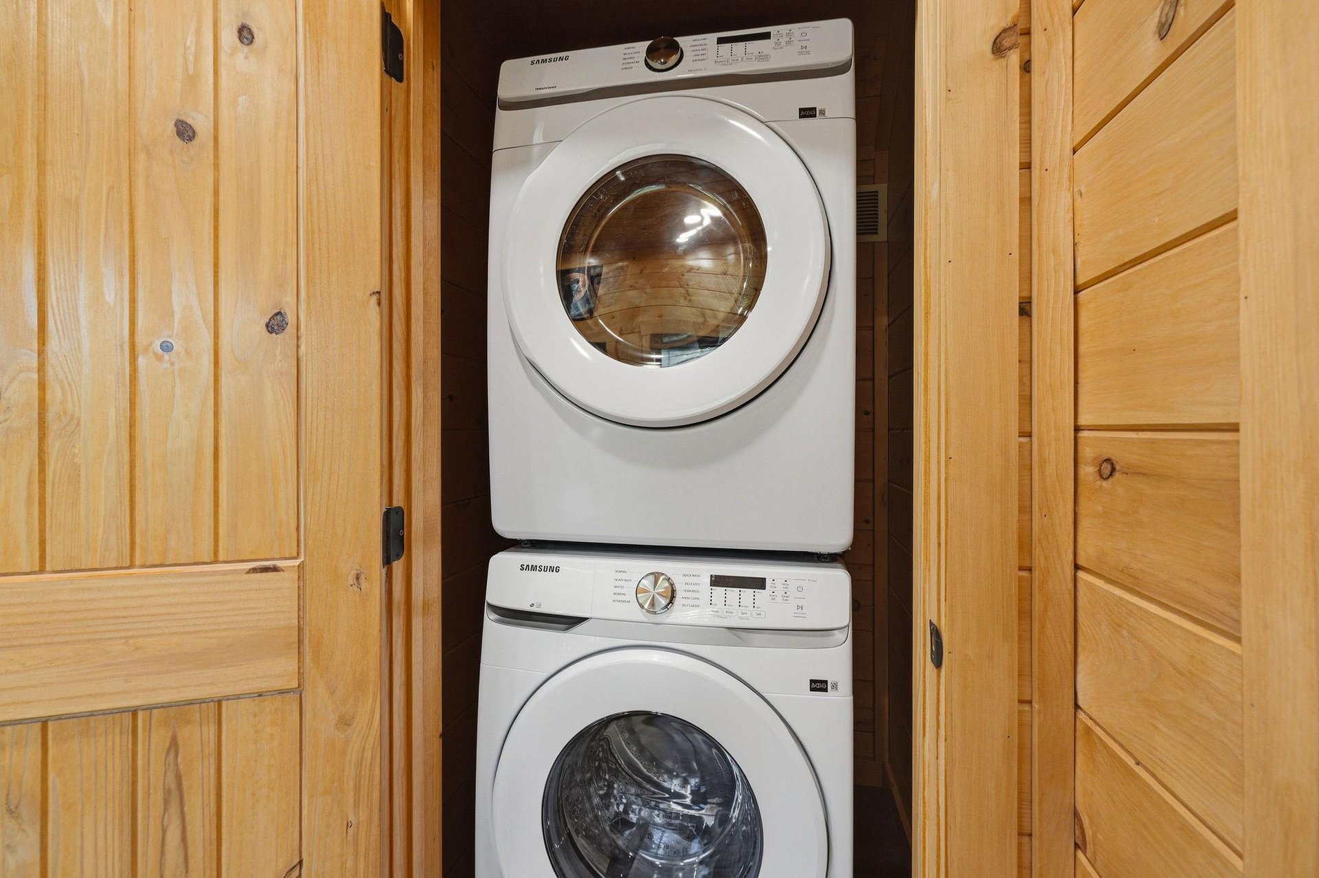 Your clothes stay fresh with this convenient inunit washer and dryer, tucked away behind beautiful wooden cabinet doors.