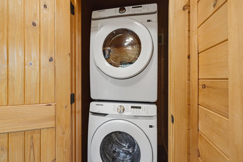 Your clothes stay fresh with this convenient inunit washer and dryer, tucked away behind beautiful wooden cabinet doors.