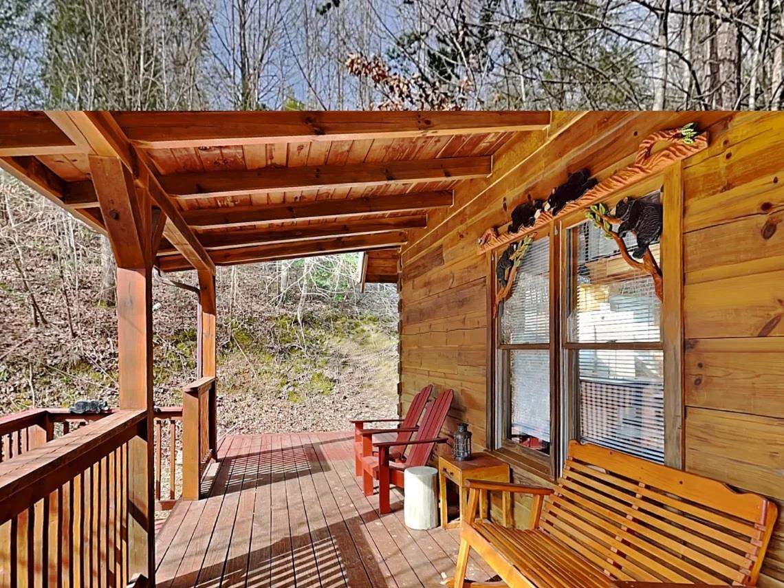Step out onto your private covered deck where Adirondack chairs and a wooden bench await, inviting you to unwind in the quiet embrace of the surrounding forest.