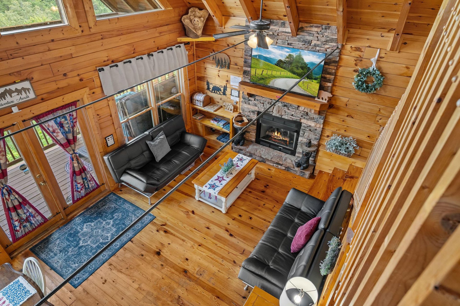 Living room with 2 futons and stone fireplace