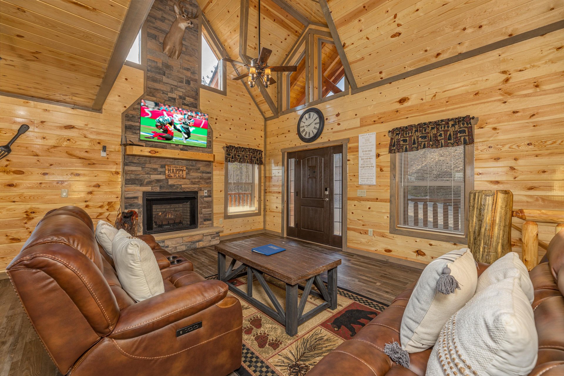 Living room with fireplace, TV, and seating at Everlys Splash, a 4 bedroom cabin rental located in Pigeon Forge