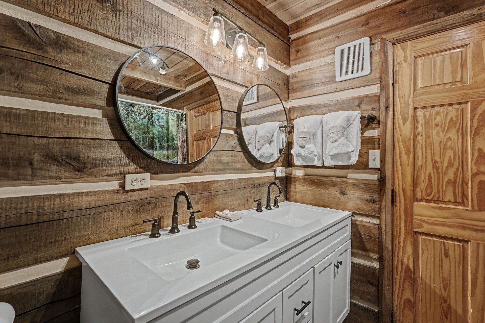 Step into your private rustic sanctuary where warm wood surrounds you and fresh towels await your relaxing retreat.