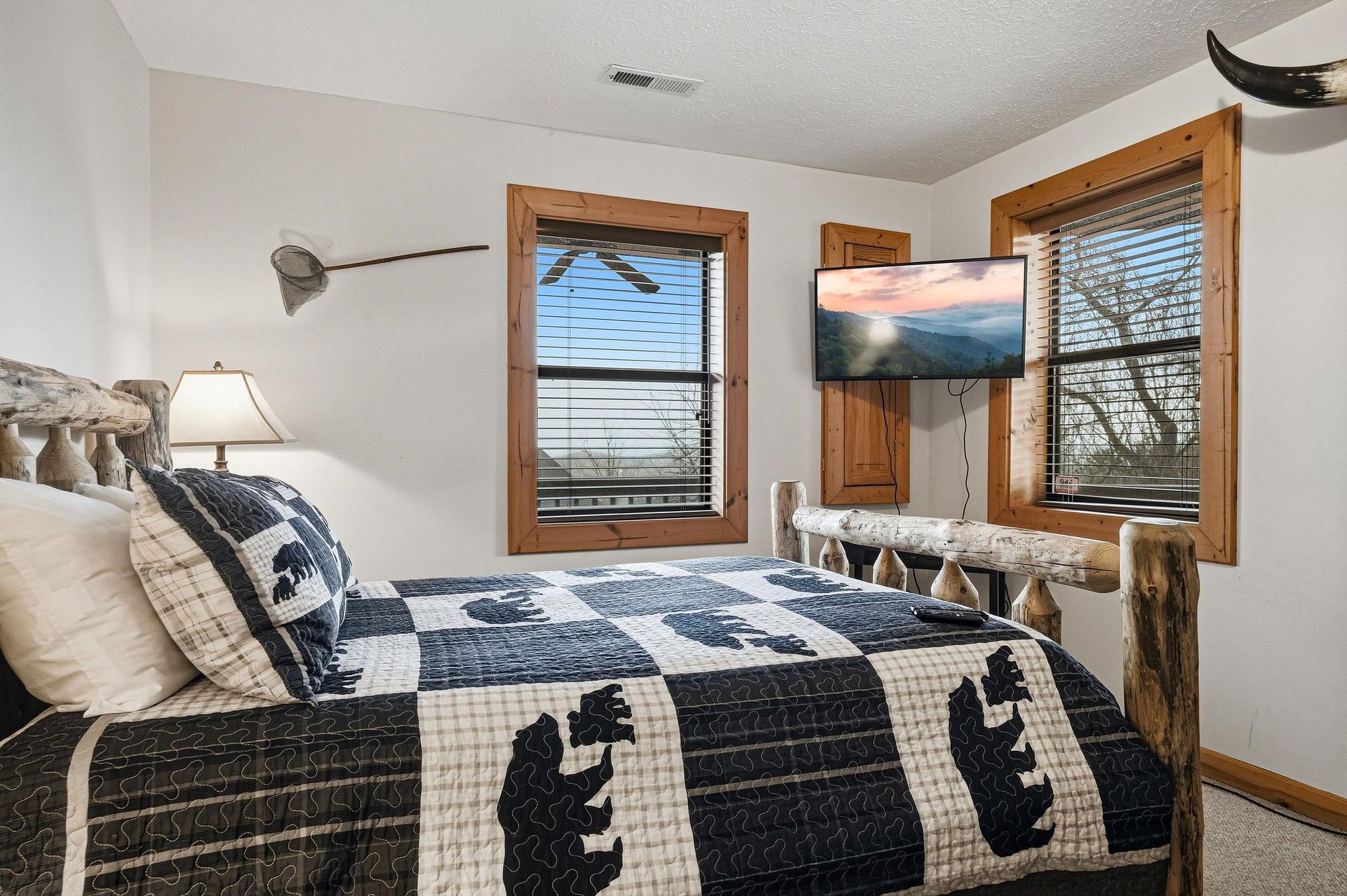 Drift off in your cozy cabin bedroom with rustic charm, featuring handcrafted log furnishings and soft mountainthemed bedding.