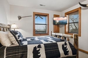 Drift off in your cozy cabin bedroom with rustic charm, featuring handcrafted log furnishings and soft mountainthemed bedding.