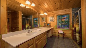 Long single vanity and a stained glass window