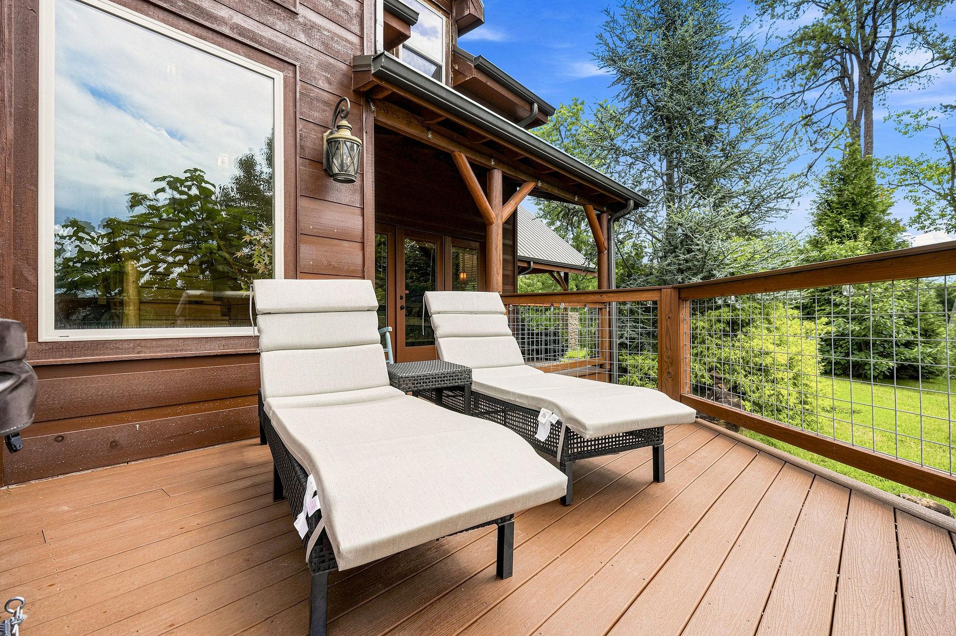 Unwind on your private deck with loungers overlooking lush greenery. Breathe in the fresh air and soak up the peaceful treetop views from this inviting outdoor space.