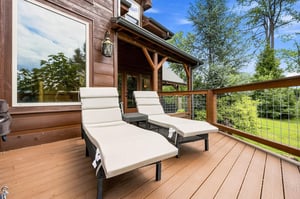Unwind on your private deck with loungers overlooking lush greenery. Breathe in the fresh air and soak up the peaceful treetop views from this inviting outdoor space.
