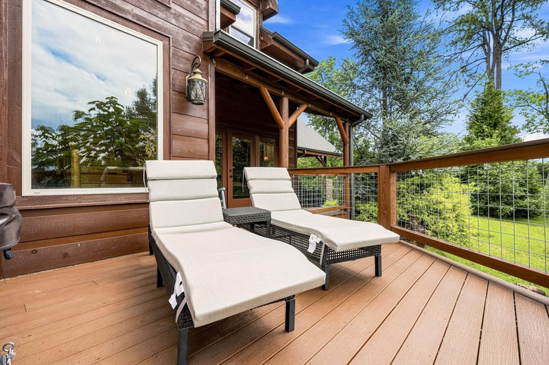 Unwind on your private deck with loungers overlooking lush greenery. Breathe in the fresh air and soak up the peaceful treetop views from this inviting outdoor space.