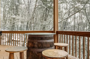 Step onto your private deck where rustic barrel seating overlooks a peaceful winter wonderland of snowladen trees.