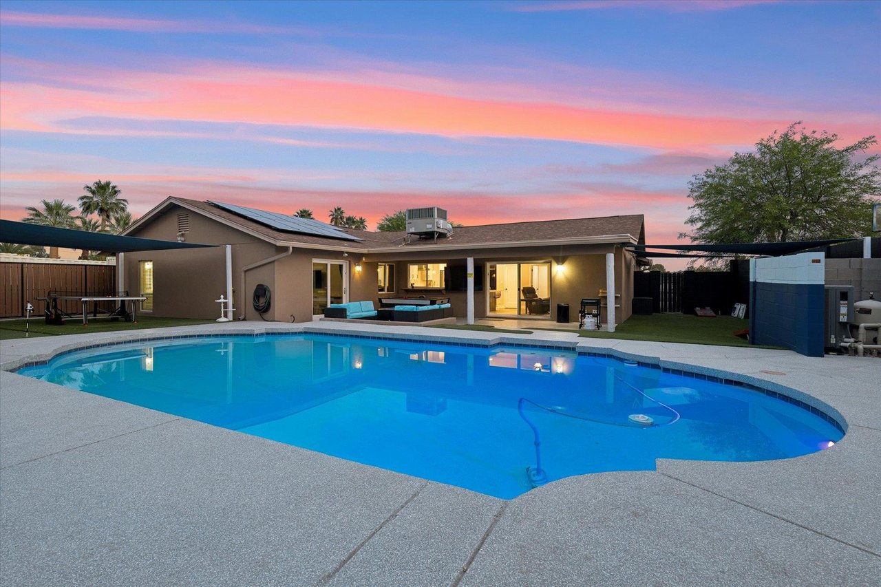 Complete with a fenced yard, private pool, covered patio, grill, firepit, cornhole, air hockey, pool table, mini golf putting green, and ping pong table.