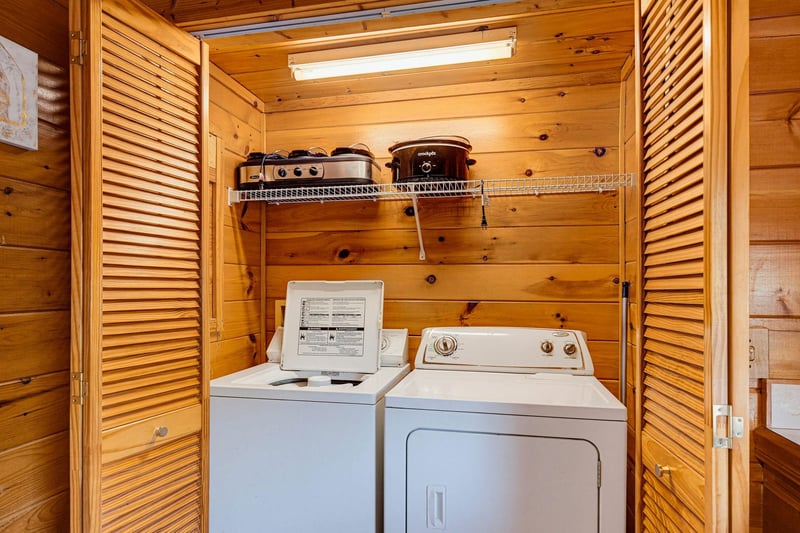 Your dedicated laundry space with washer and dryer, nestled in warm wood paneling for easy inunit convenience.