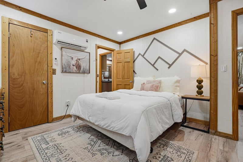 Rest peacefully in your cozy mountaininspired bedroom with crisp linens, rustic wood beams, and modern comforts like AC for perfect temperature control.