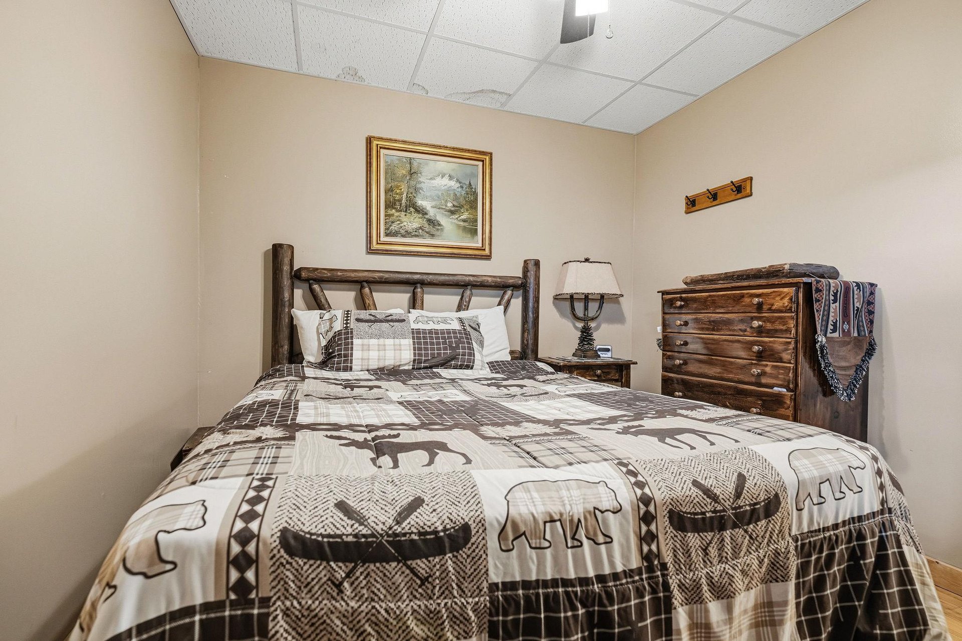 Your cozy rustic bedroom features handcrafted log furniture and wildlifethemed bedding that creates the perfect mountain cabin atmosphere.