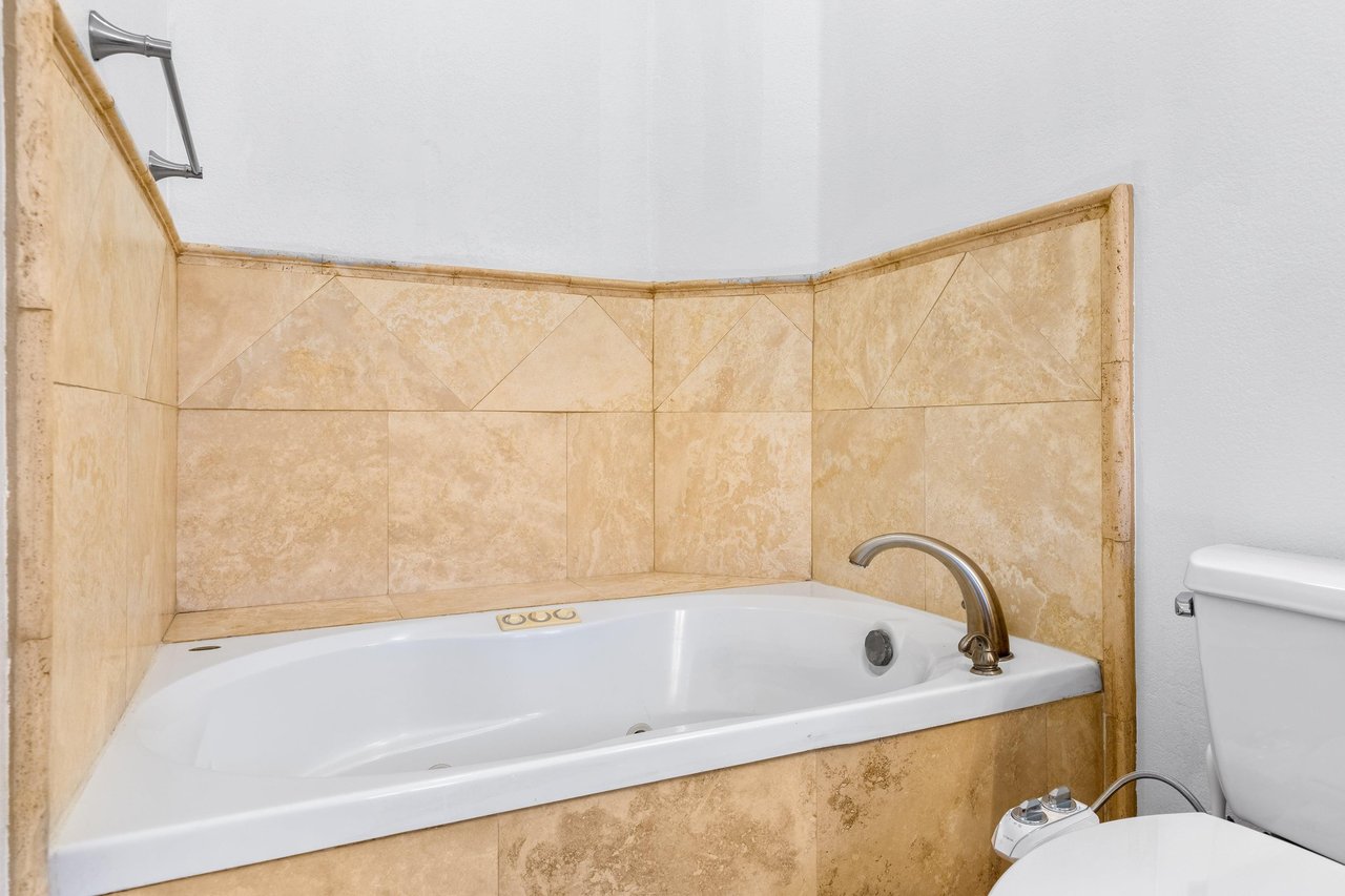 Dual vanity sink, walkin shower, and standalone jet tub.