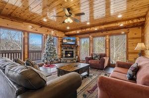 Your cozy cabin living room wraps you in warmth with rustic wood walls, a crackling fireplace, and plush leather seating perfect for mountain relaxation.