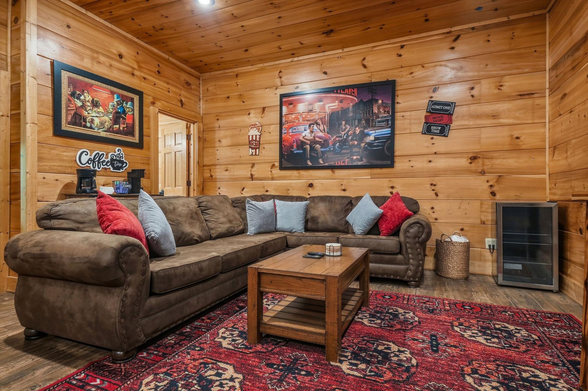 Sink into the plush sectional and let the warmth of knotty pine surround you in this inviting living room, perfect for cozy evenings together.