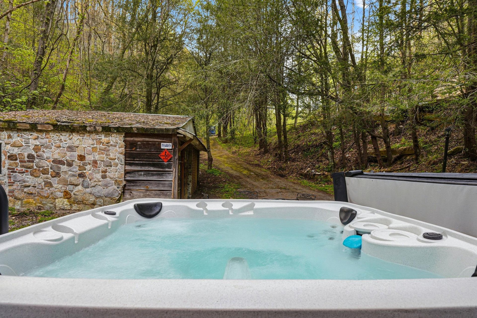 Soak in your private hot tub surrounded by peaceful woodland, where rustling leaves create natures soundtrack for your ultimate relaxation.
