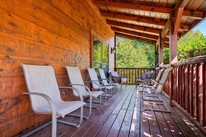 Settle into your own shaded sanctuary, where rows of comfortable seating invite you to unwind and enjoy views of the surrounding greenery from this expansive covered deck.