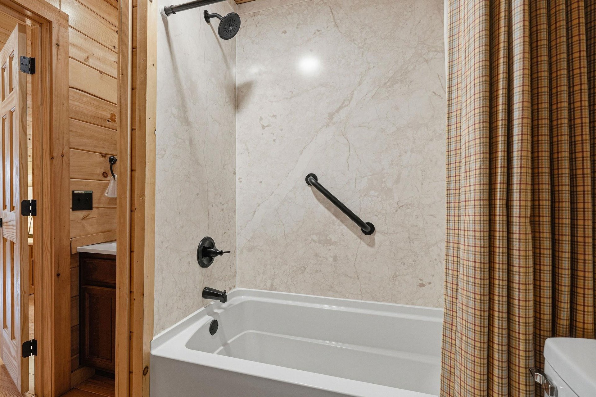 Unwind in your marblewalled bathtub after mountain adventures, with accessible grab bars and rainfall shower for comfort.
