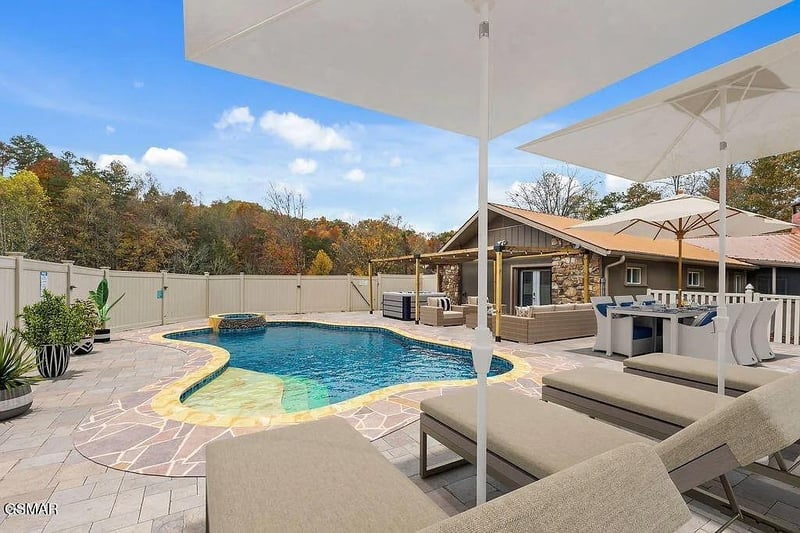 Unwind poolside with stunning fall foliage views  your perfect backyard oasis awaits with comfortable loungers and shade umbrellas.