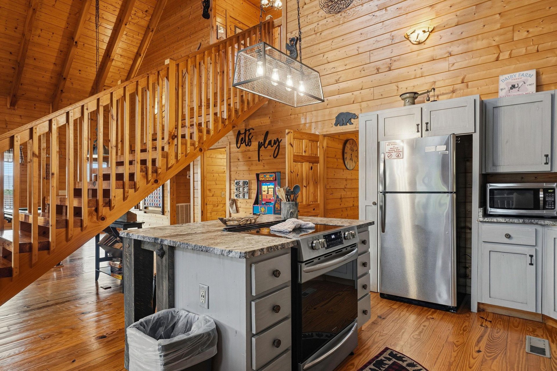 Step into your cozy cabin retreat where rustic charm meets modern comfort. The spacious kitchen invites you to whip up meals with friends while the warm wood surroundings create the perfect mountain g
