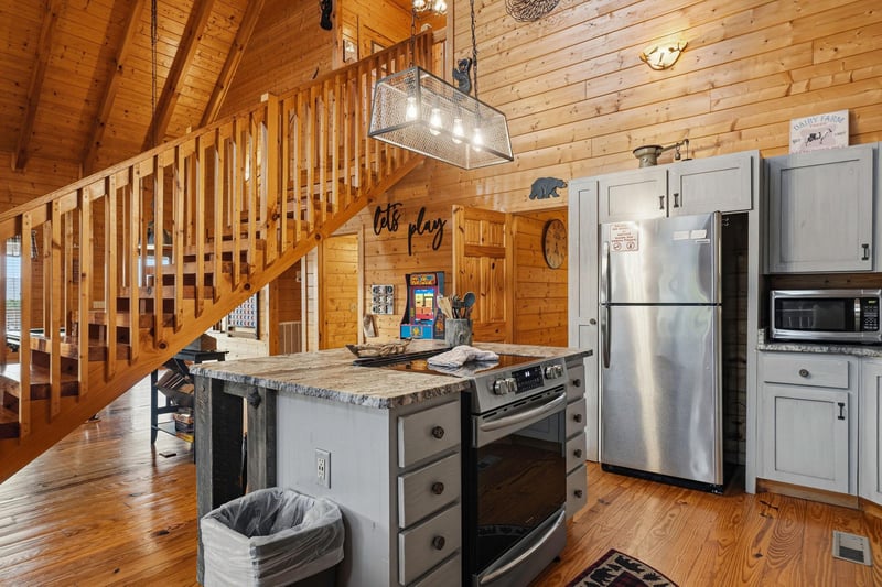 Step into your cozy cabin retreat where rustic charm meets modern comfort. The spacious kitchen invites you to whip up meals with friends while the warm wood surroundings create the perfect mountain g