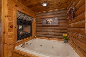 Jacuzzi and a doublesided fireplace at A Lovers Secret, a 1 bedroom cabin rental located in Gatlinburg