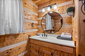 Single vanity sink with round mirror